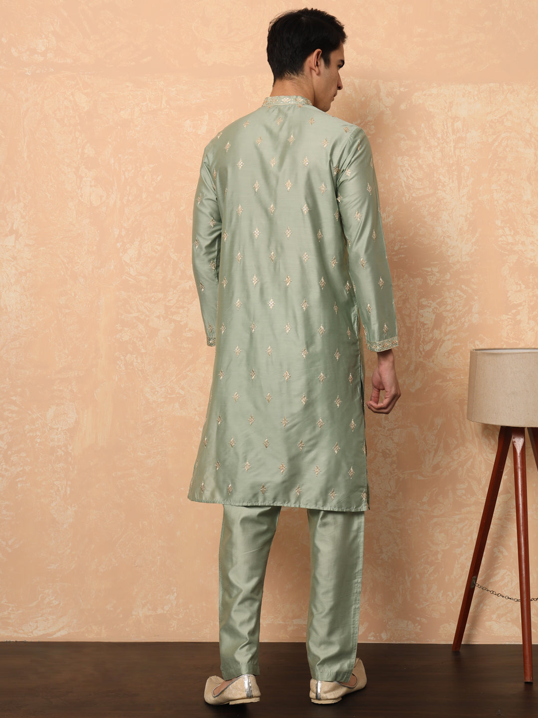 Olive green kurta set with golden thread work butta and collar.