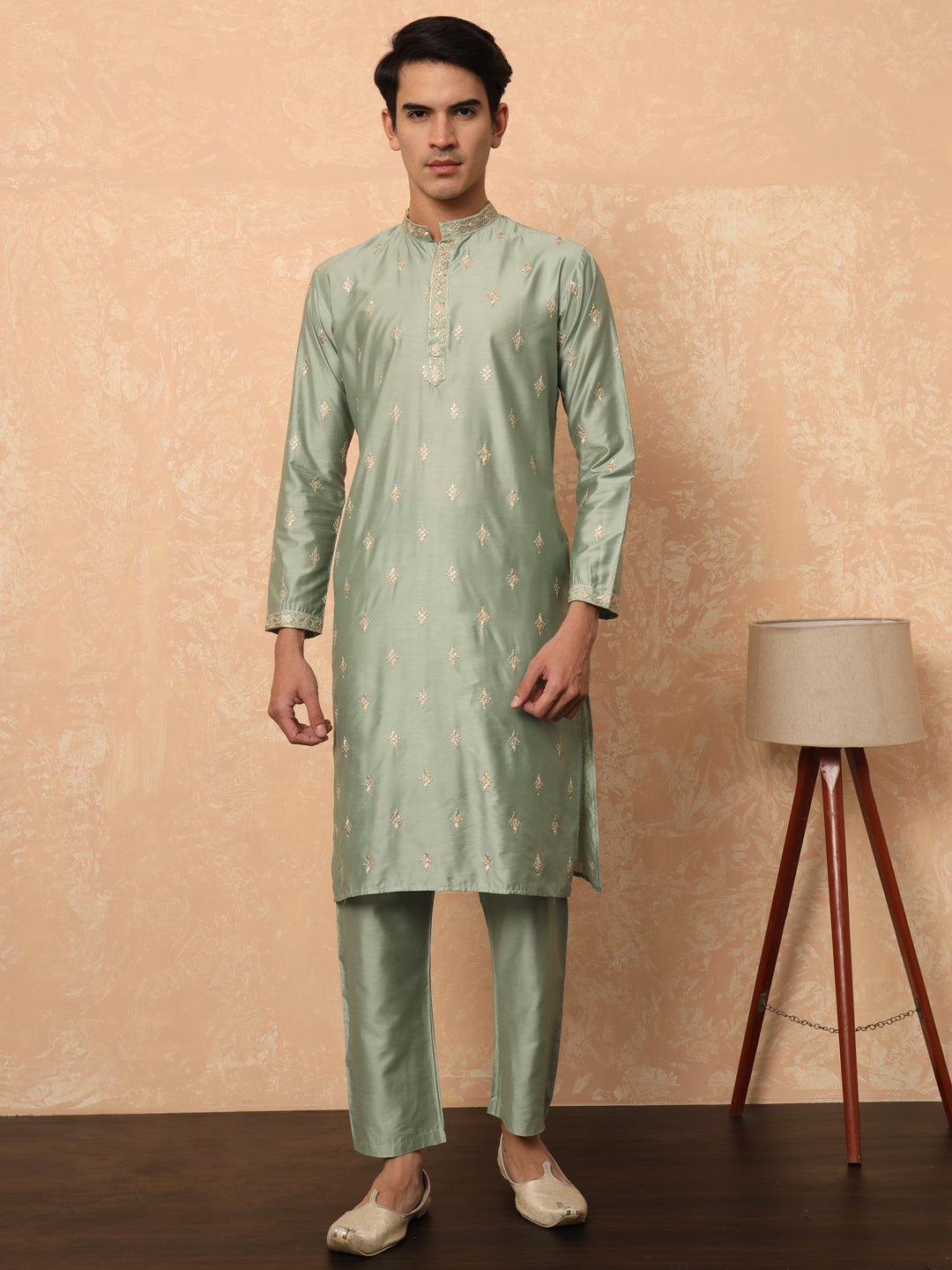 Olive green kurta set with golden thread work butta and collar.